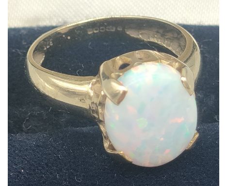 9ct yellow gold ring set with a large oval cabochon opal gem stone. [Ring size N] [3.47Grams] 