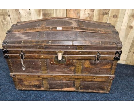 19th century dome top trunk; leather and wooden panelled, Leather handles to the side. Ball bearing feet. [68x94x52cm] 