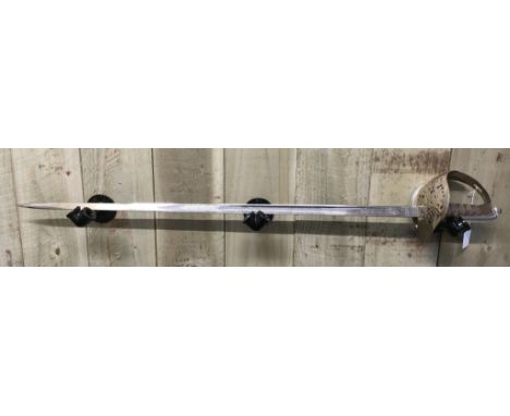 A circa 1890 George VI Royal Marines Officers Presentation Sword with fitted leather sheath produced by Wilkinson swords make