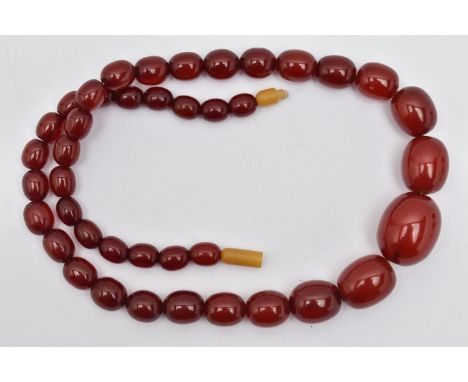 A GRADUATED CHERRY AMBER, BAKELITE BEAD NECKLACE, graduated oval beads, smallest measuring approximately 10.5mm x 8.7mm, larg