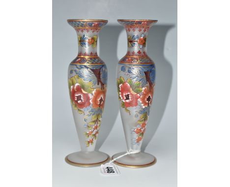 TWO ATLANTIS GLASS FOOTED VASES, painted with flowers and foliate or geometric borders, having gilt highlights, each signed '