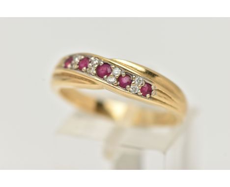 AN 18CT RUBY AND DIAMOND HALF ETERNITY RING, cross over design set with five circular cut rubies interspaced with small round