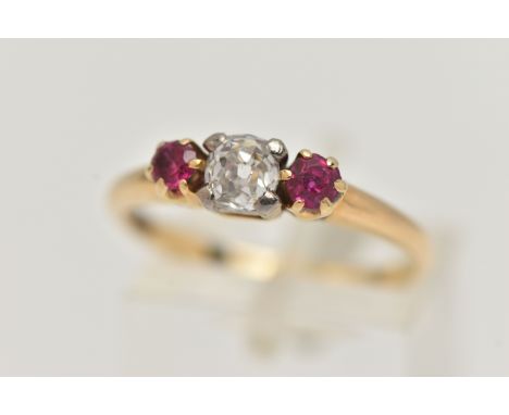 A YELLOW METAL DIAMOND AND RUBY THREE STONE RING, centering on an old cut diamond, estimated diamond weight 0.40ct, measuring