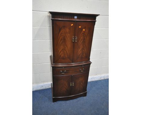 A 20TH CENTURY MAHOGANY STRONGBOW FURNITURE BOW FRONT COCKTAIL CABINET, fitted with four cupboard doors, a brushing slide and