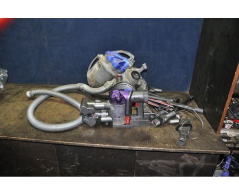A DYSON DC31 HANDHELD VACUUM with wall bracket, charger and a quantity of accessories along with a Dyson DC19 Allergy vacuum 