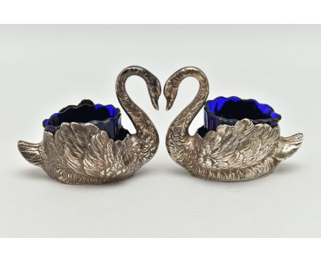 A PAIR OF GEORGE V SILVER NOVELTY SALTS, matching swans with feather detail, with blue glass inserts, approximate height 56mm