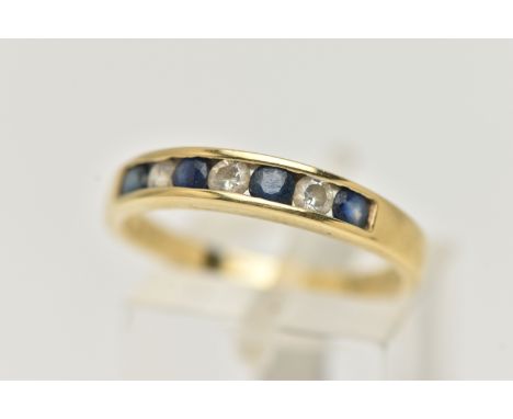 AN 18CT GOLD SAPPHIRE AND DIAMOND HALF ETERNITY RING, set with four deep blue circular cut sapphires, interspaced with three 