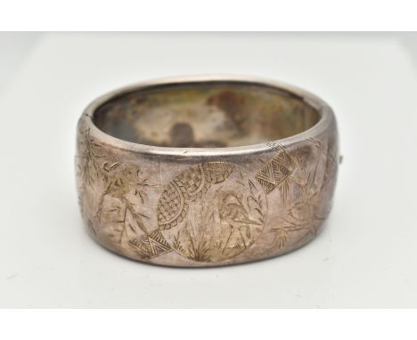 A WHITE METAL HINGED BANGLE, wide bangle engraved with an oriental design, fitted with a push button, integrated box clasp, u