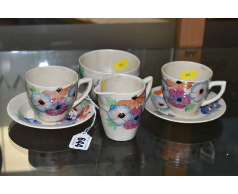 A SIX PIECE CLARICE CLIFF 'ANEMONE' PART TEA SET, comprising two teacups and saucers, a cream jug and a sugar bowl, painted w