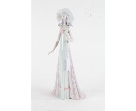 Lladro figurine, in the form of a lady wearing a flowing dress and hat, 35cm, together with a Nao and Lladro figurine smaller