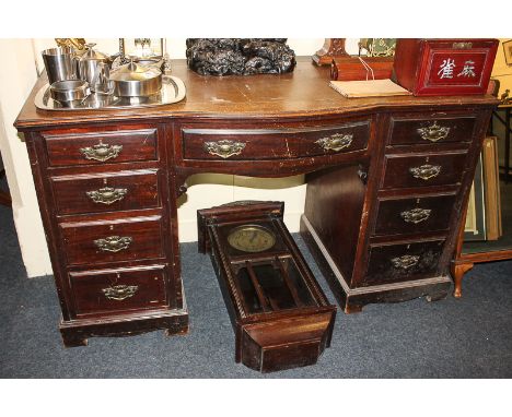 A late Victorian mahogany desk with leather inset top (a/f), bowfront centre and drawer and two banks of four drawers on brac