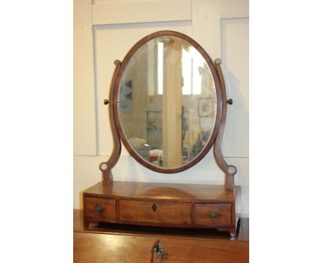 A George III oval dressing table mirror, on bowfront box base with three drawers, on bracket feet, 46cm