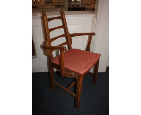 An Arts and Crafts oak ladder-back carver dining chair with upholstered seat