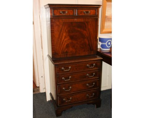 A small reproduction mahogany secrétaire a abattant, with two short drawers over fall front enclosing fitted interior of pige