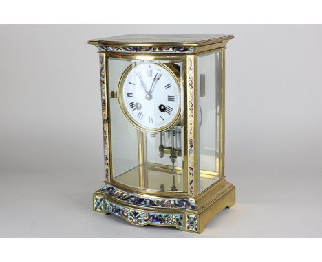 A French gilt metal and enamel mantel clock with circular white enamel dial, movement striking on a gong, marked France, with