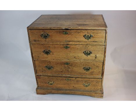 A Victorian pine chest of four drawers, with brass drop handles, on shaped bracket base, 76.5cm