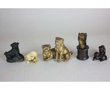 A gilt metal figure group of two pug dogs, two Netsuke with pugs, another modern black composition figure of a pug, 5cm high,
