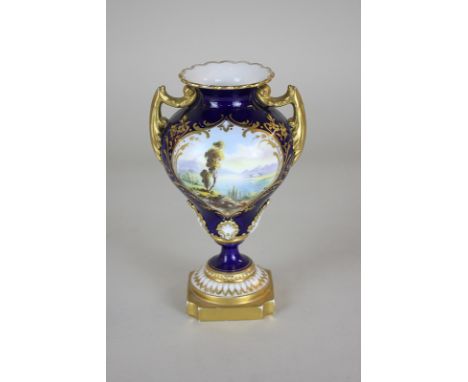 A Royal Worcester porcelain small baluster urn, the hand painted panel depicting a countryside lake scene on blue ground with