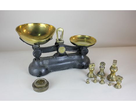 A set of cast iron kitchen scales, with brass dishes and assorted weights 32cm