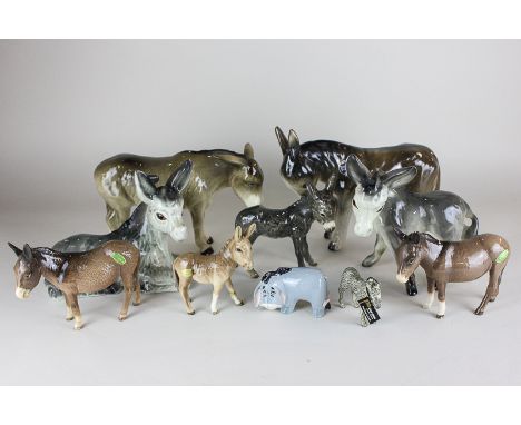 Three Beswick models of Donkeys, comprising two second version Donkeys No. 1364B, and a foal No. 2110 together with a Goebel 