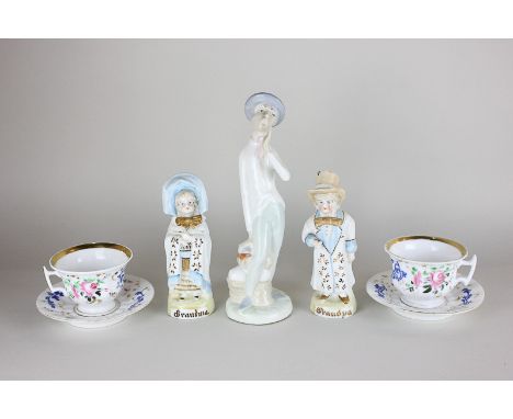 A pair of German pottery figures titled Grandma and Grandpa, a Spanish porcelain figure and a pair of floral and gilt decorat