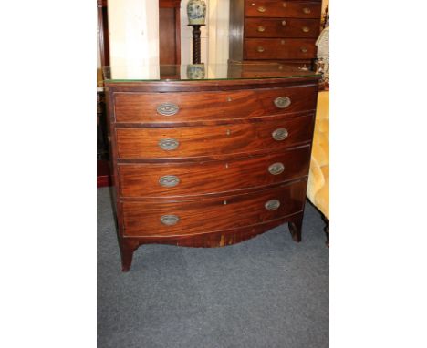 A 19th century mahogany bow front chest of four graduated drawers, with brass oval drop handles, on shaped bracket feet (a/f)