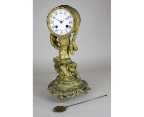 A gilt metal mantle clock, drum shaped dial marked John Bennett, London, supported by a cherub on scroll base (a/f) 34cm high