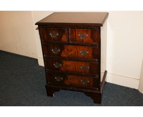 A reproduction mahogany small chest of two over three drawers with drop handles, on bracket feet, 45cm