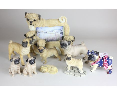 A collection of modern pug dog models, including a photograph frame with four pug dog surround, four other composition pugs, 
