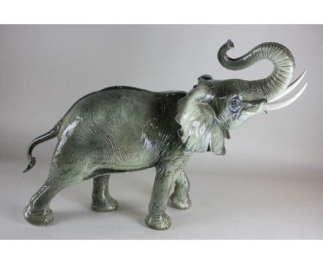 A large Goebel porcelain model of an elephant, with trunk raised