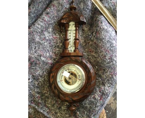 A 20th century carved mahogany wall barometer and thermometer 46cm high