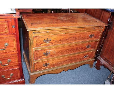 A reproduction inlaid walnut chest of three drawers, on shaped bracket feet, 89cm