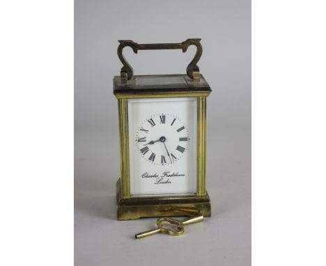 A gilt brass and bevelled glass cased carriage clock,  the face marked Charles Frodsham, London 15cm high (TG)