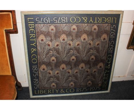 A Liberty & Co silk scarf in glazed frame, with central peacock feather design and border reading 'Liberty & Co 1875-1975', 8