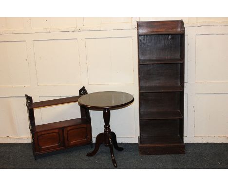 A mahogany wall shelf with two cupboards and fret cut supports, 57cm, a narrow bookcase on plinth base, 40cm, a mahogany trip