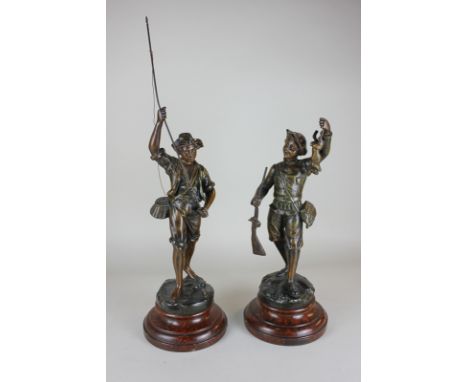 After G Omerth, a pair of spelter figures of boys hunting and fishing, on wooden bases, bearing signature, 54cm high includin