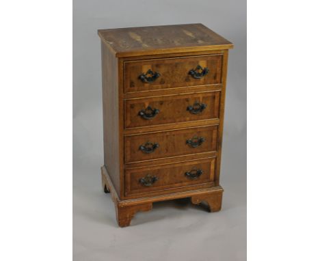 A yew small chest of four drawers with drop handles, on bracket base,  44cm
