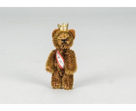 A Schuco miniature Berlin teddy bear 1950s, with brown mohair, metal pin eyes, black stitched nose, jointed metal framed body