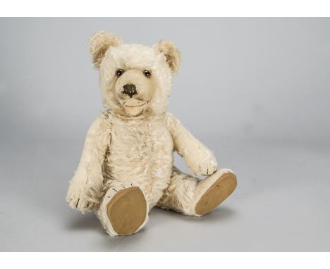 A post-war Steiff Teddy Baby, with light golden mohair, brown and black glass eyes, inset short mohair muzzle and tops of fee