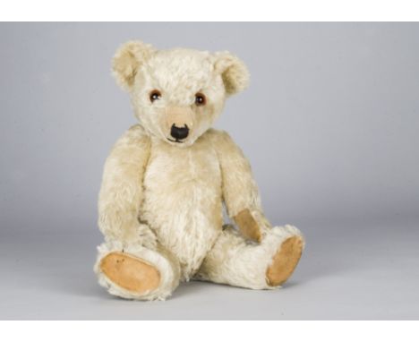 A rare white Chiltern Hugmee teddy bear 1930s,  with orange and black glass eyes, pronounced clipped muzzle, black stitched n