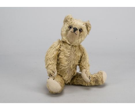 An early British teddy bear 1920s,  with light golden mohair, clear and black glass eyes with brown painted back, upturned cl