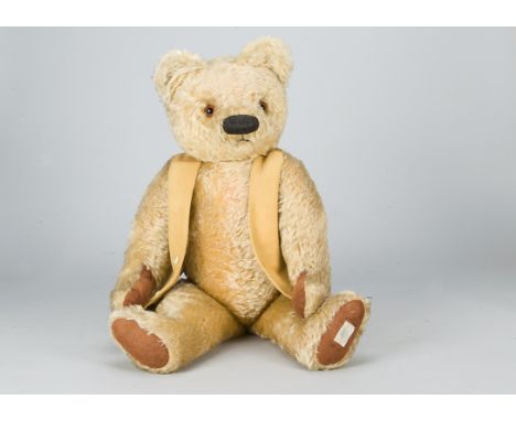 A large post-war Chad Valley teddy bear,  with golden mohair, orange and black glass eyes, black stitched large oval bulbous 