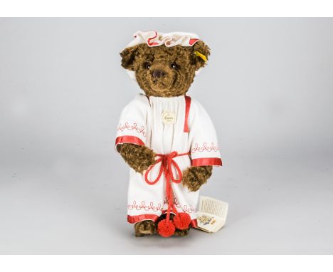 An unusual Steiff yellow tagged Classic 1907 Teddy Bear with Stimmeabwaschbar,  in original white felt dress and hat with red