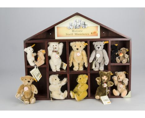 Historic Steiff Miniatures display shelf, wooden house shaped with twelve small and miniature yellow tagged bears including t