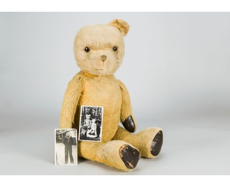 A large British teddy bear with provenance 1920s, with golden mohair, orange and black glass eyes, brown stitched nose and mo