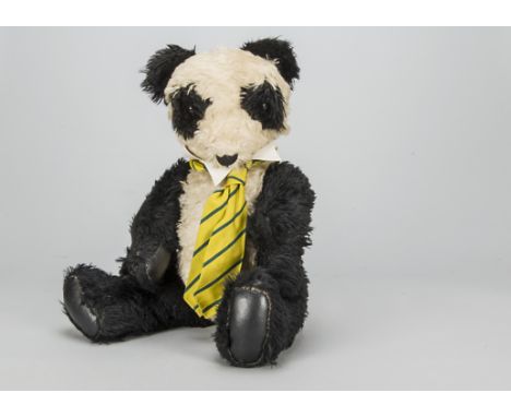 A post-war panda, probably British with black and white synthetic mohair mixed plush, orange and black glass eyes, swivel hea