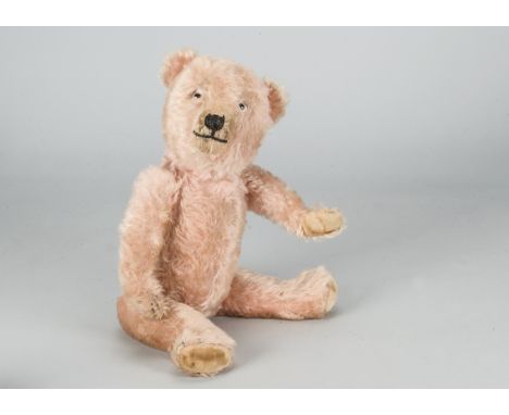 A 1930s Chiltern-type pink mohair teddy bear,  with clear and black glass eyes, black stitched nose, mouth and claws, swivel 