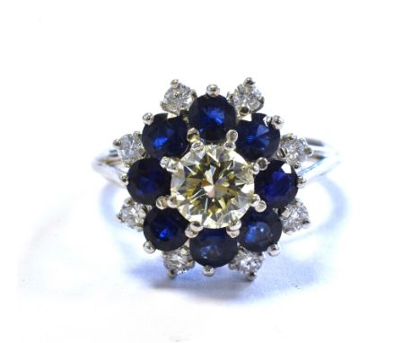 18CT WHITE GOLD SAPPHIRE &amp; DIAMOND RING 14.7mm floral cluster head, set with a central round brilliant cut diamond, estim