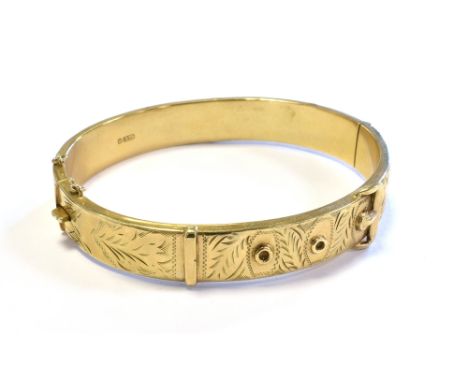 9CT GOLD BELT BANGLE 10.2mm wide with engraved detail and buckle motif to front, plain back.  Hallmarked '9.375 Birmingham 19