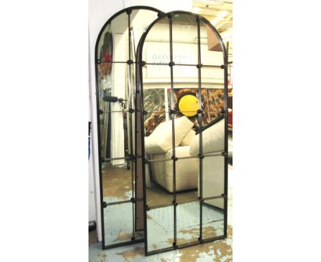 ARCHITECTURAL MIRRORS, a pair, with arched top in a black metal frame, 180cm x 71cm. (2)